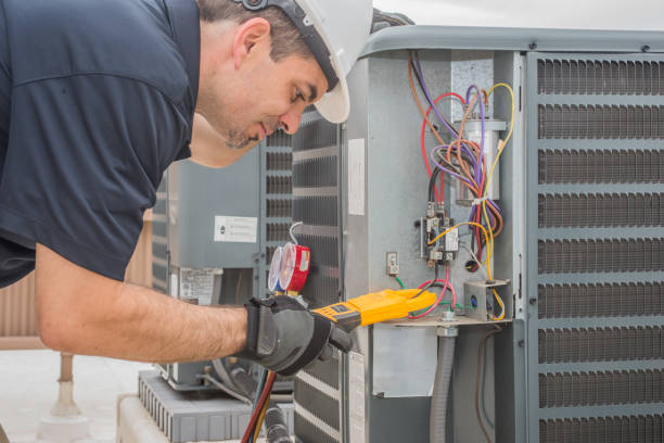professional hvac technician measuring amperage on an air conditioner unit